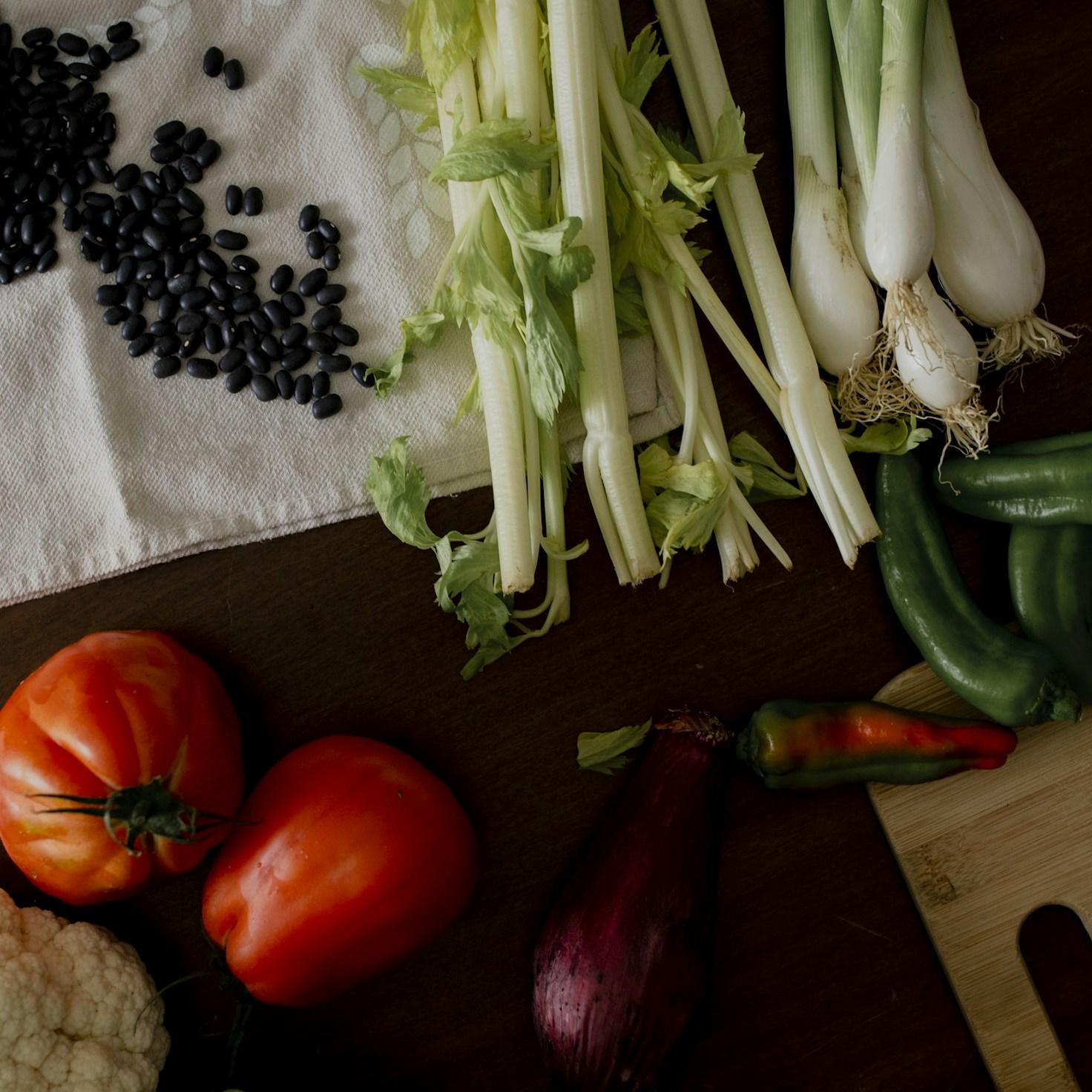 Diverse group of community members sharing a meal together, showcasing the social bonds formed through collaborative cooking